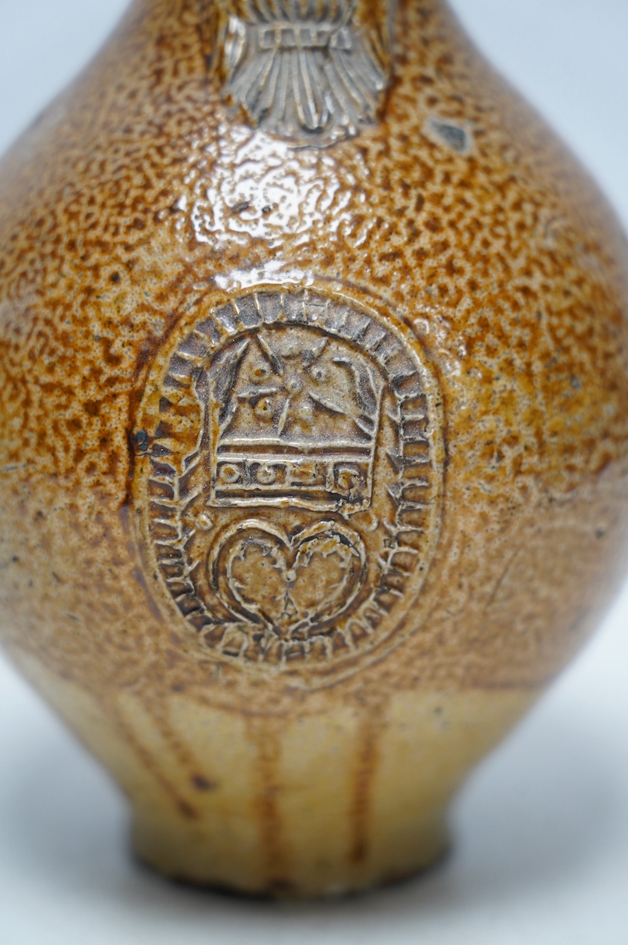 A 17th century Rhenish saltglazed Bellarmine, 23cm. Condition - commensurate with age